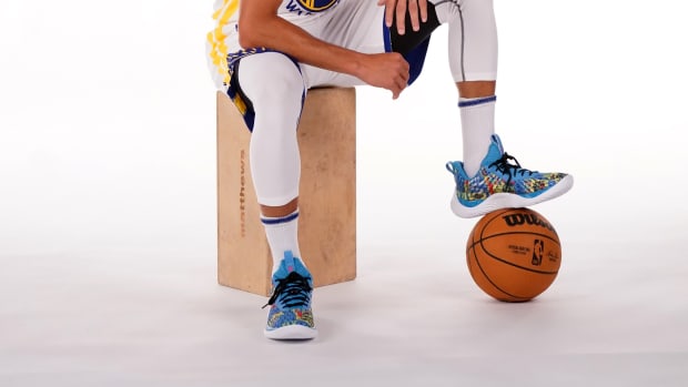 Stephen Curry sits down during photo shoot.